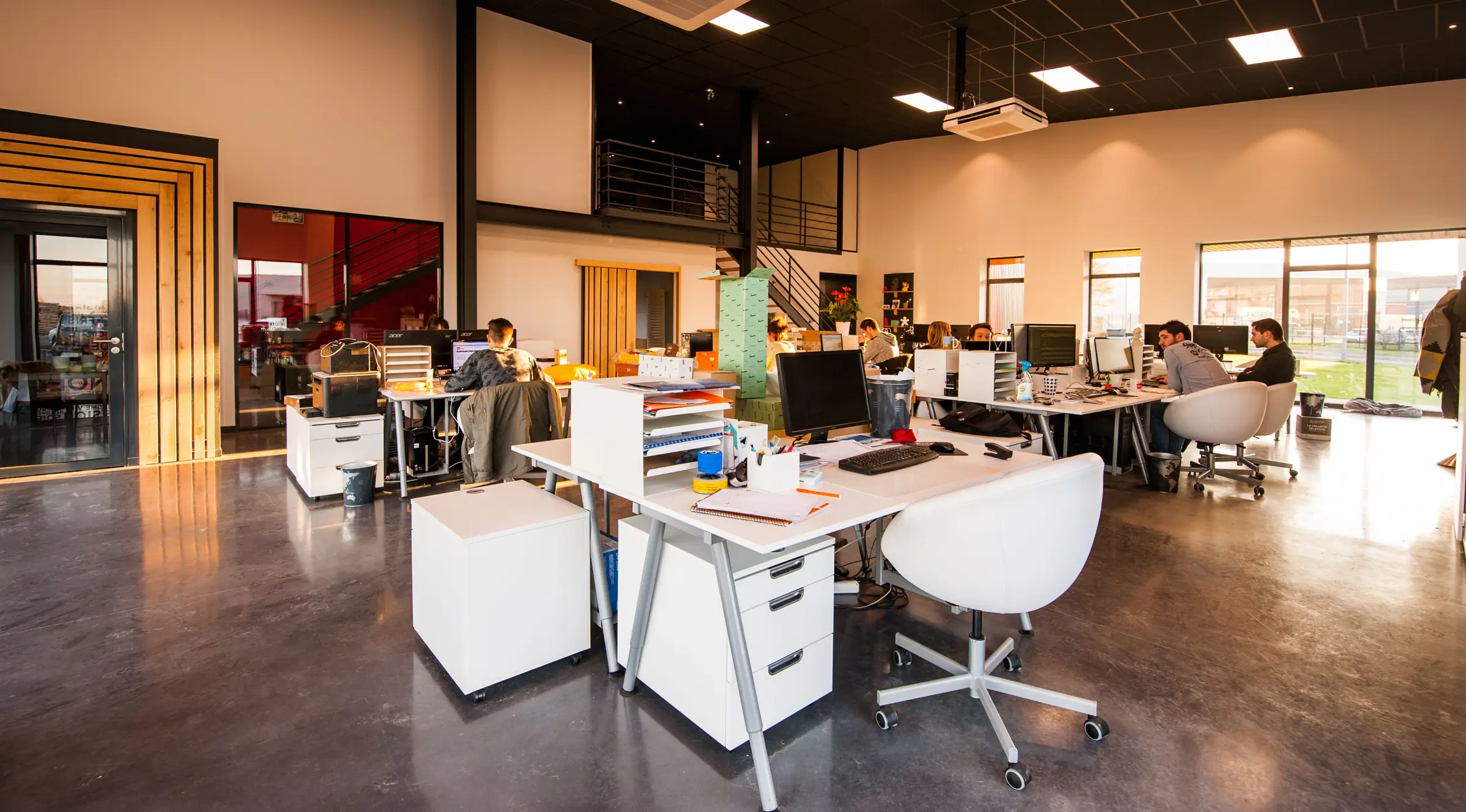 Bright open-plan office with freshly painted white walls and high ceilings