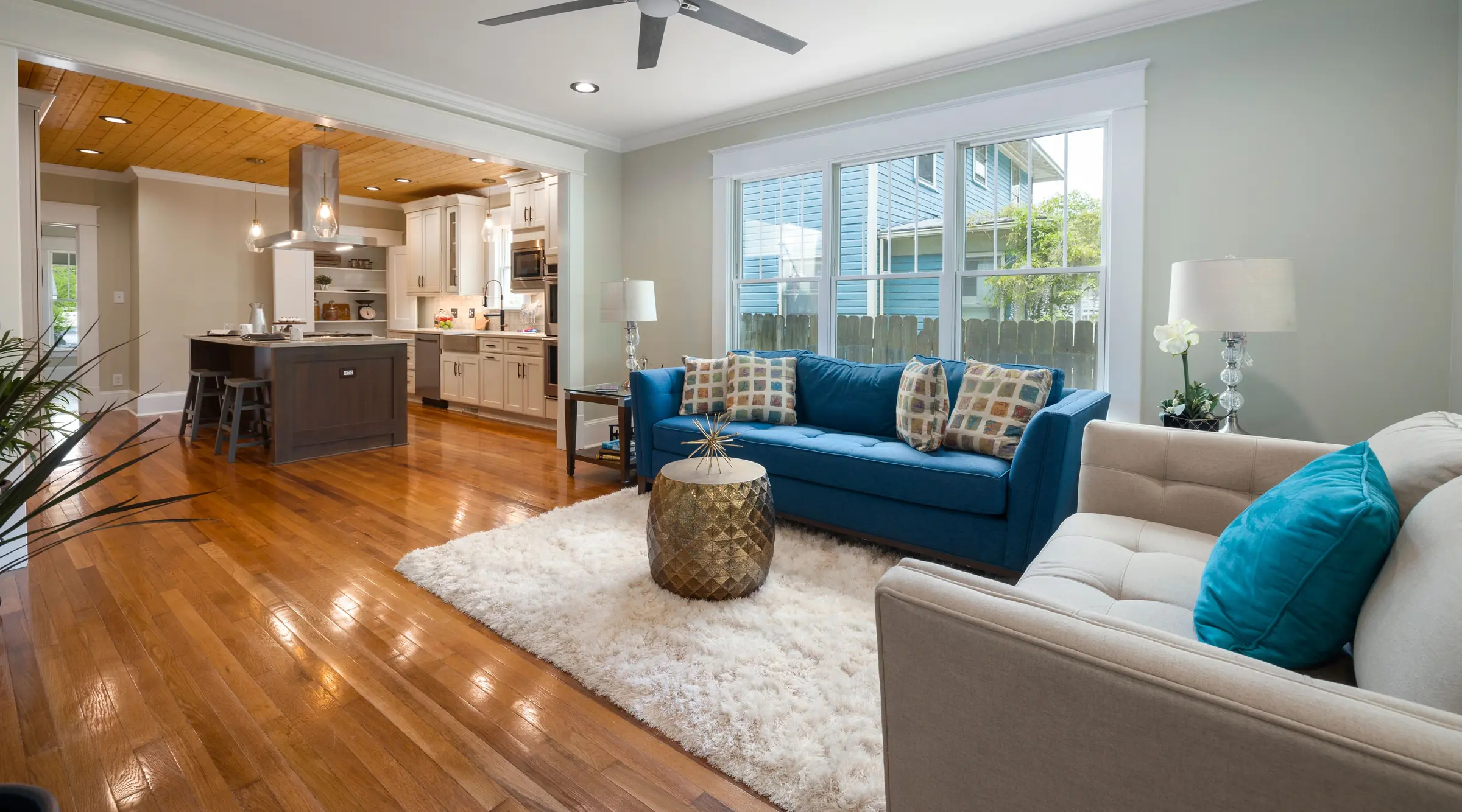 Freshly painted living room with soft green walls, white trim and hardwood floors